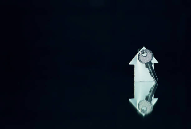 istock House and key on a black  background. 873447782