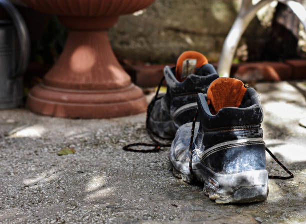istock Old dirty working boots. Shoes overage. Shoes which have walked many kilometers 873449542