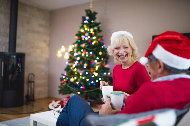 istock Senior couple drinking tea and talking on Christmas 873452172