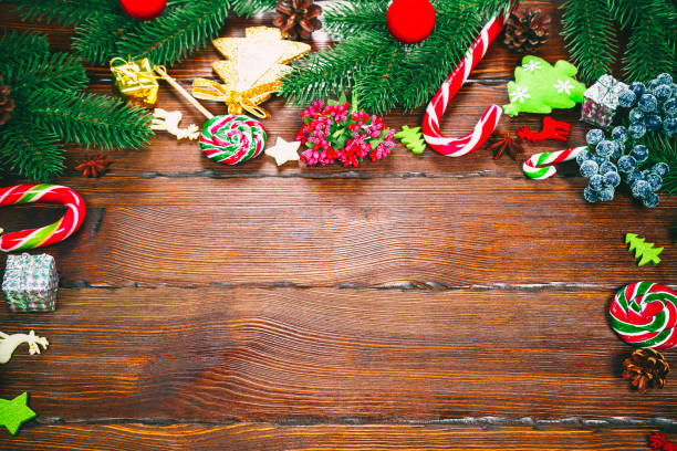 istock Christmas background with Christmas tree branches, ornaments, candy and decorations. Free space 873457676