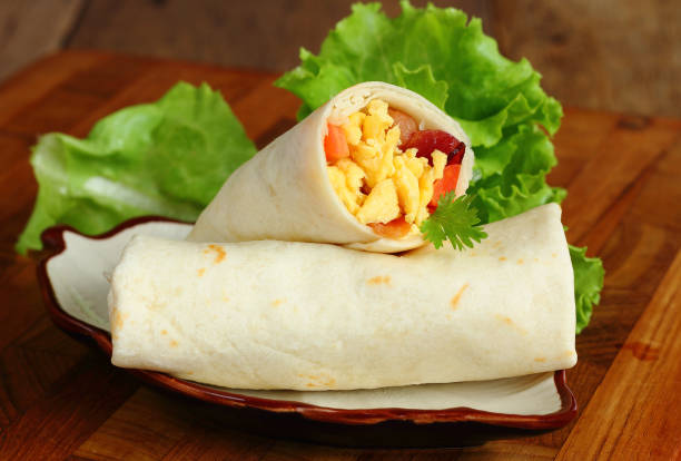 istock Burritos wraps with omelet ham and vegetables. 873459238