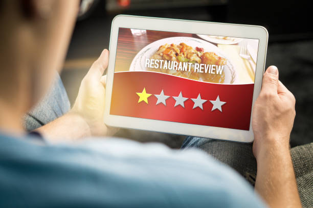 schlechte restaurantbewertung. enttäuscht und unzufrieden kunden schreckliche bewertung mit tablet auf einer imaginären kritik website, anwendung oder website geben. - restaurant review stock-fotos und bilder