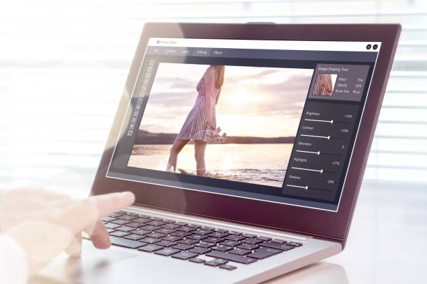 Photo editing. Professional editor retouching an image with laptop and imaginary computer software. Photo editing. Professional editor retouching an image with laptop and imaginary computer software. All graphics are made up. retouching stock pictures, royalty-free photos & images