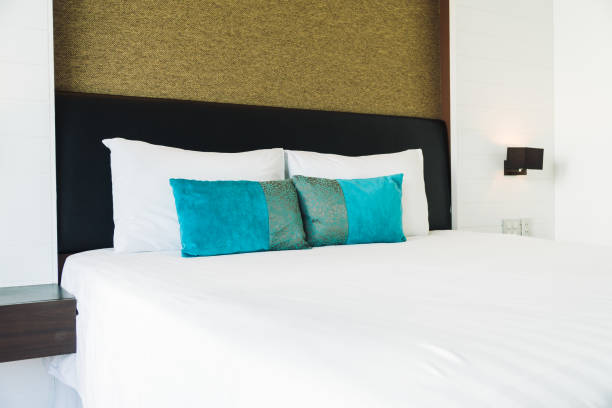 istock Pillow on bed decoration in bedroom interior 873462554