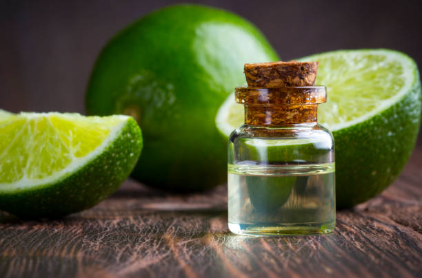 istock lime oil citrus wooden vintage background 873462880