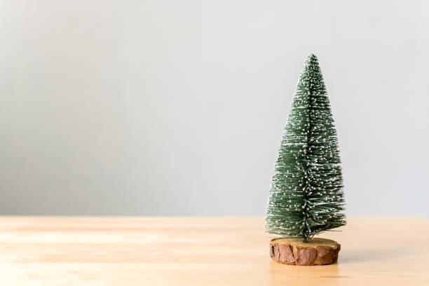 istock Christmas tree on wood table with white wall background, Christmas holiday celebration concept, Copy space 873468640