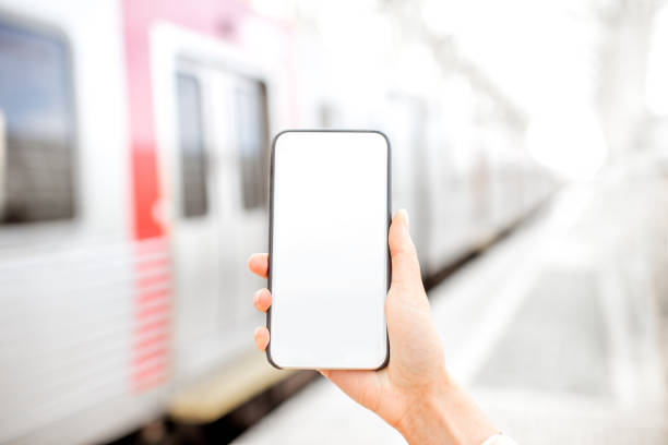 istock Holding phone at the railway station 873469530