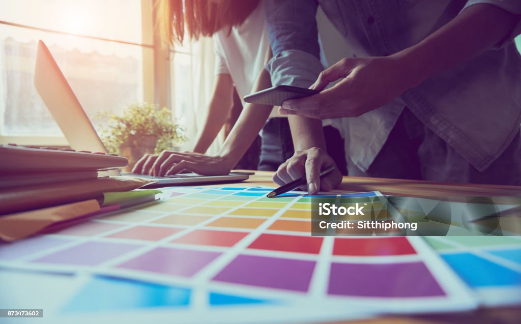 teamwork, Young businesswoman in office in casual shirt. Selecting information with colleagues with a computer on the table. Business Marketing Planning Advertisement Stock Photo