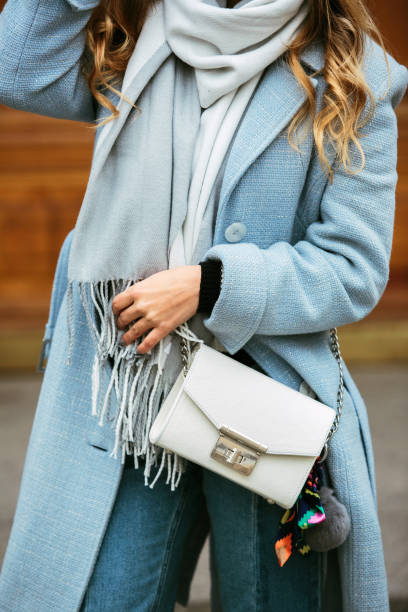 Croped picture at fashion handbag girl posing on street. Model looking aside. Lady wearing stylish autumn clothes. Croped picture at fashion handbag girl posing on street. Model looking aside. Lady wearing stylish autumnclothes. womens blue suede shoes stock pictures, royalty-free photos & images