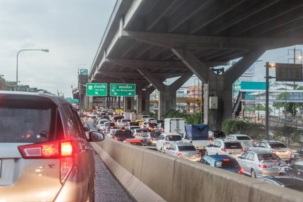 Cars on busy road in the Bangkok city, Thailand. Many cars use the street for transportation in rushhour with a traffic jam stock photo