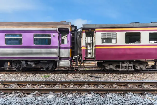 Photo of Railway train on the railroad tracks in Bangkok station. Many people in Thailand popular travel by train because it is cheaper.