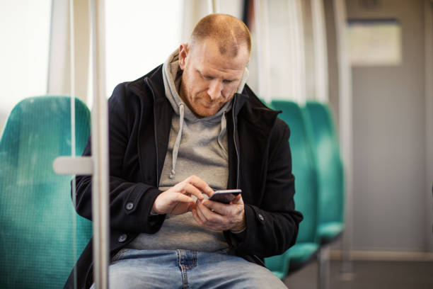 istock Handsome redhead middle aged man traveling on public transport 873487566