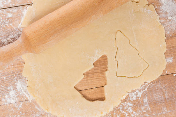 istock on a wooden board dough for a Christmas cookie, rolling pin, on a table 873488438