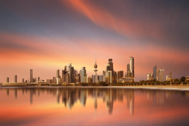 Beautiful view of kuwait city skyline with reflection during sunset stock photo