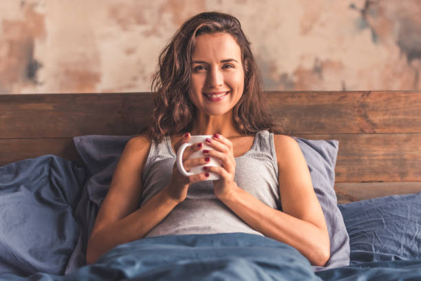 istock Young woman in bed 873488802