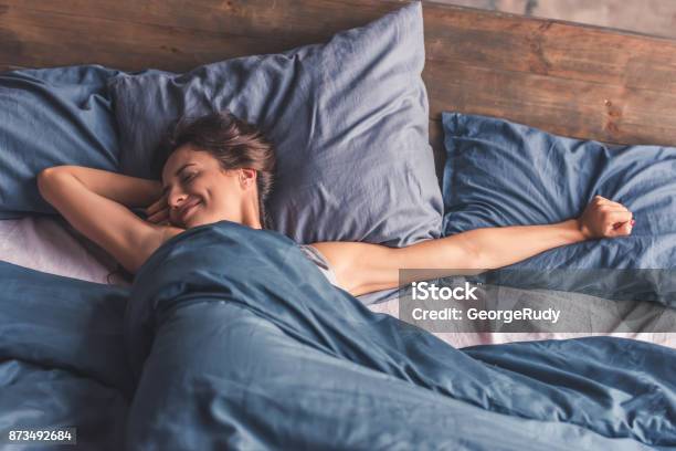 Young Woman In Bed Stock Photo - Download Image Now - Sleeping, Bed - Furniture, Women