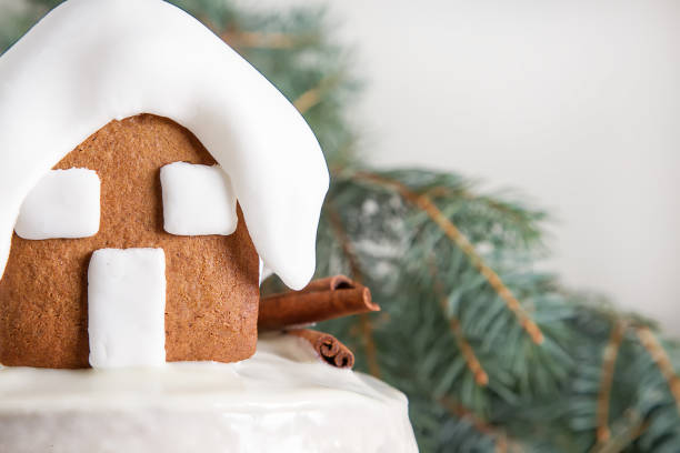 New Year cake with Christmas trees and gingerbread houses and cinnamon. Light background.