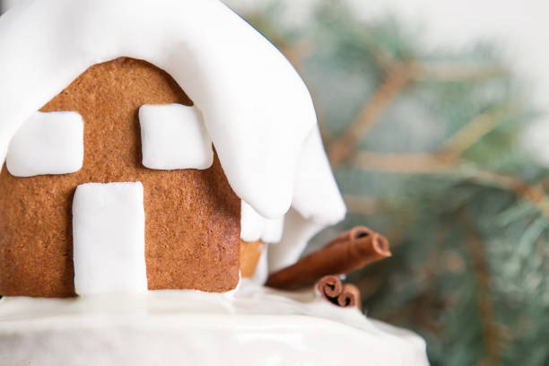 New Year cake with Christmas trees and gingerbread houses and cinnamon. Light background.