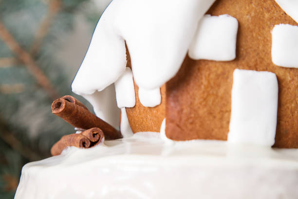New Year cake with Christmas trees and gingerbread houses and cinnamon. Light background.