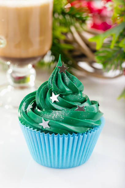 istock Green christmas cupcake with festive decorations 873515718