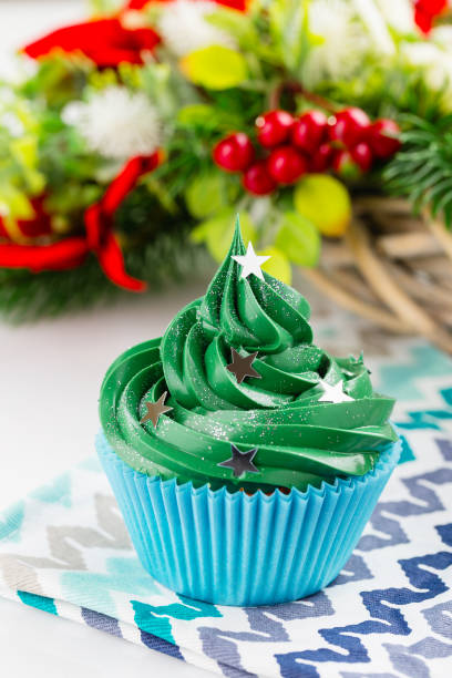 istock Green christmas cupcake with festive decorations 873515732