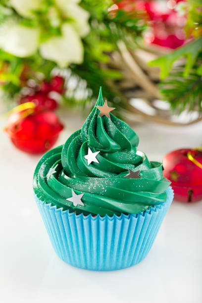istock Green christmas cupcake with festive decorations 873515796