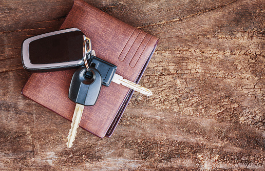 Travel Holiday with car keys and wallet on the wooden table. copy space.
