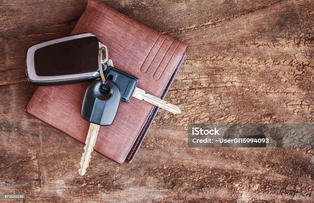 Travel Holiday with car keys and wallet on the wooden table. copy space. Key Stock Photo