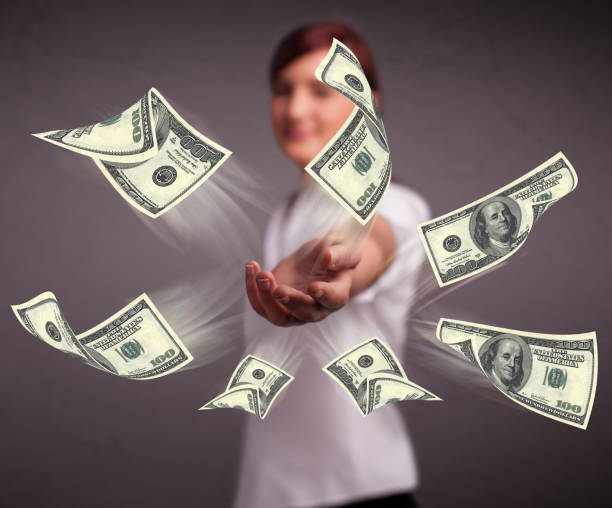 istock Young girl throwing money 873526622