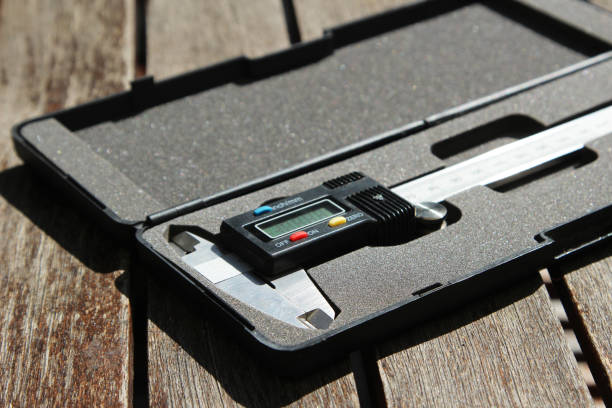 istock A Vernier caliper on a wooden table top. This image can be used to represent measurement or engineering. 873534714