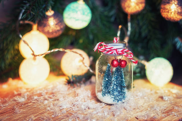 istock Two small art Christmas trees in a glass jar 873538926