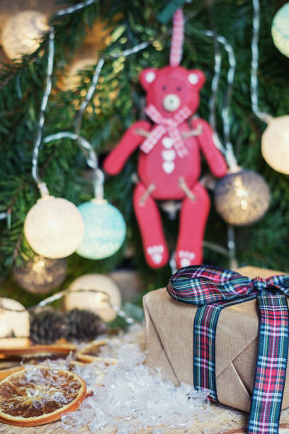 istock Red wooden bear hanging in Christmas branch 873539764