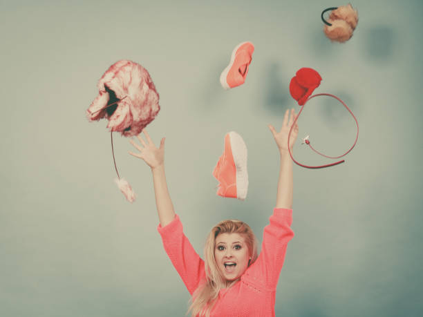 istock Shocked woman throwing clothes above head 873542696