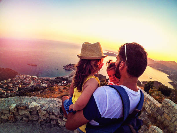 istock Father with two daughters enjoy in sunset 873544350