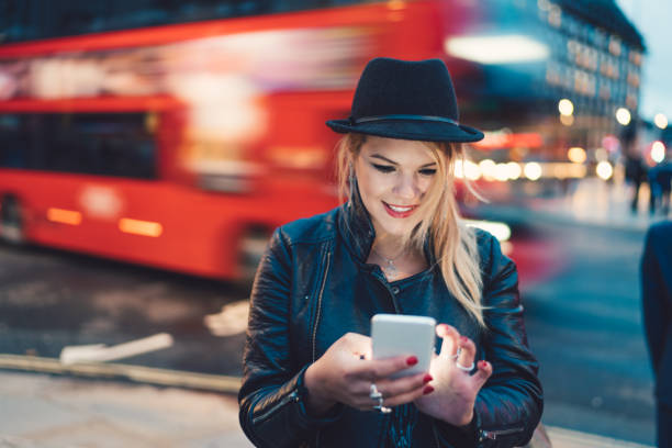 istock Cute girl in London using smartphone 873547000