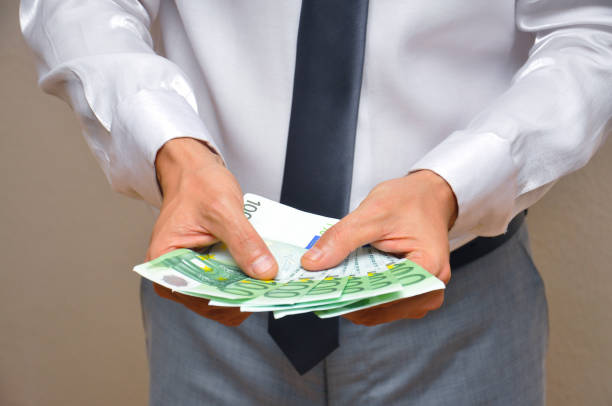 istock Man hands holding pile of money. 873547776