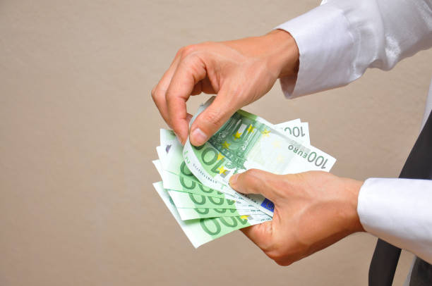 istock Man hands holding pile of money. 873548020