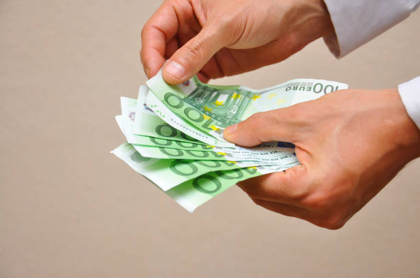 istock Man hands holding pile of money. 873548068