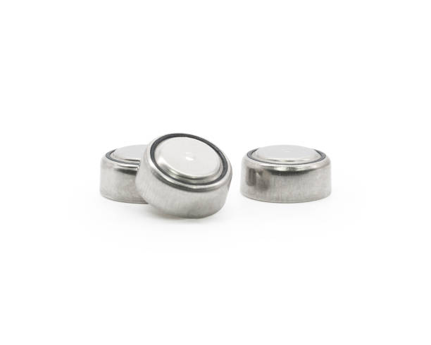 button cell on isolated background. small watch lithium battery ( clipping path or cutout object for montage ) - button battery imagens e fotografias de stock