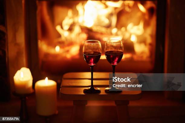 İki Bardak Kırmızı Şarap Şömine Yakın Stok Fotoğraflar & Şarap‘nin Daha Fazla Resimleri - Şarap, Mum - Aydınlatma Ürünleri, Akşam yemeği