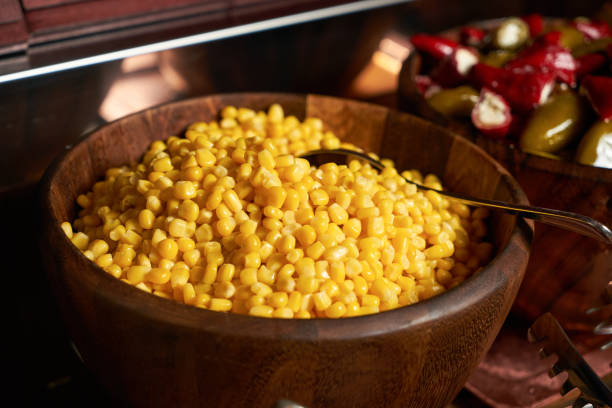 istock Sweet corn kernels in wooden bowl. 873554996