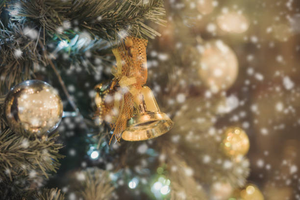 istock Golden bell with christmas ornaments on christmas tree 873557552