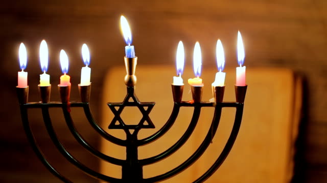 Hanukkah menorah with burning candles. Retro old style
