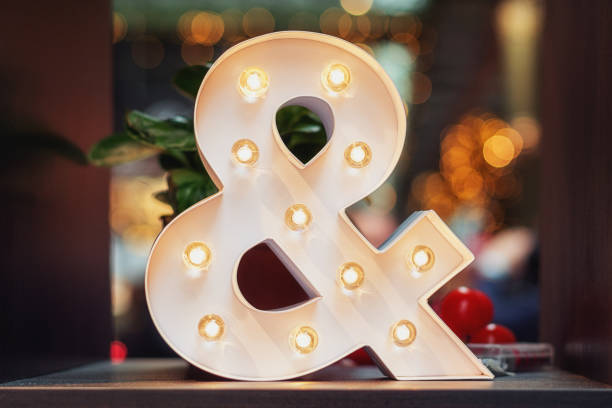 istock A huge illuminated ampersand on the table 873560464