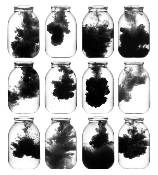 istock Luminous paint swirling in water. 873563276