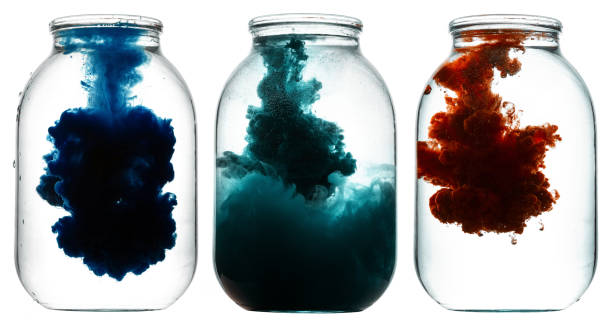 istock Luminous paint swirling in water. 873563348