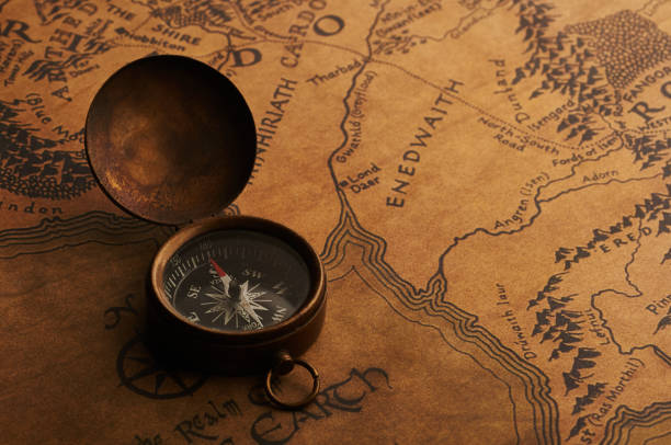 istock Old compass on a vintage map. Treasure and adventure search 873563496
