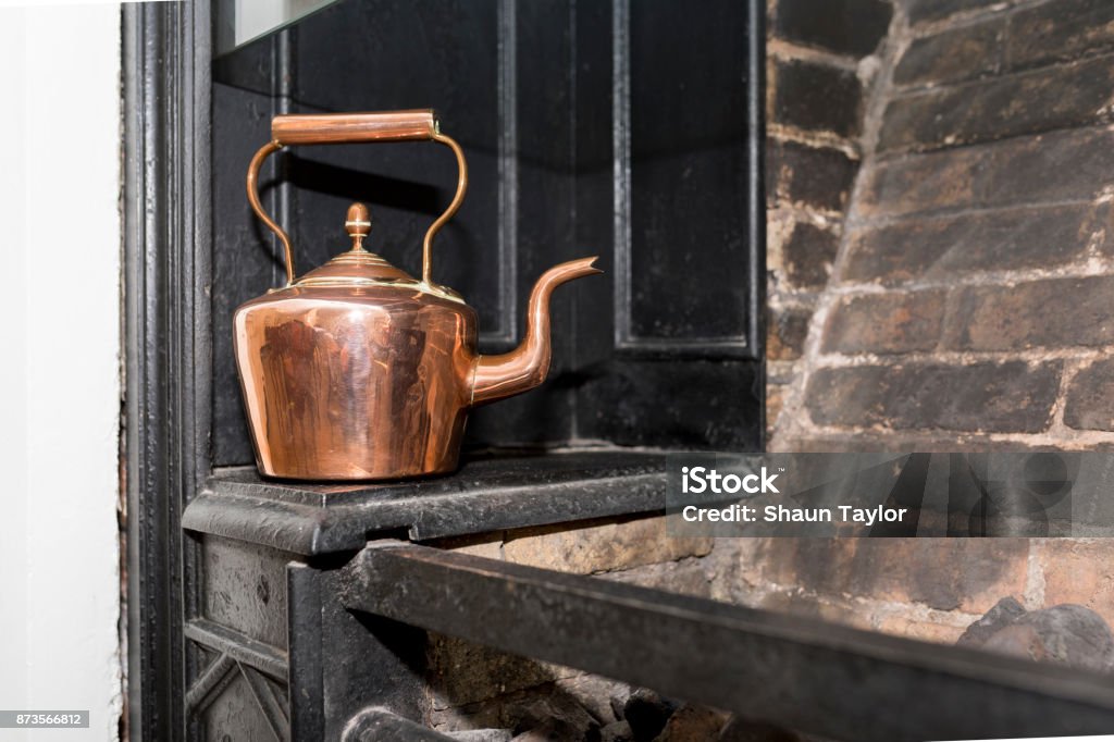 Vintage and antique copper kettle on a Victorian stove in a traditional Victorian kitchen in England, United Kingdom Victorian Style Stock Photo