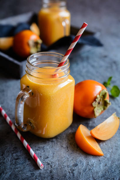 istock Persimmon smoothie in glass jars 873569848