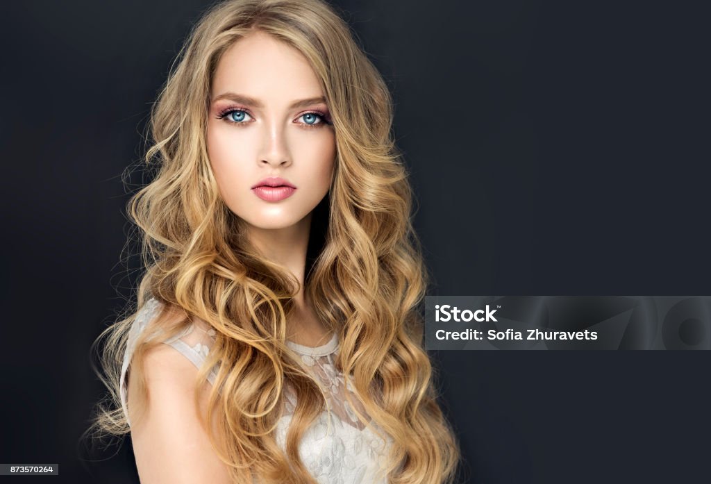 Young Blonde Haired Beautiful Model With Long Wavywell Groomed Hair Stylish  Loose Hairstyle With Freely Lying Curls Stock Photo - Download Image Now -  iStock